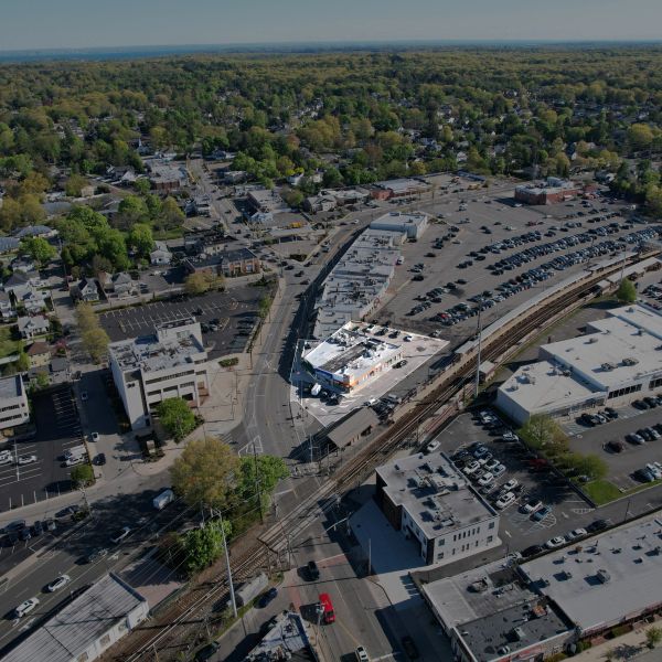 Aerial view of a suburban area with roads, buildings, and parking lots.