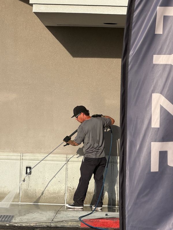 Ryno Wash Services pressure washing a commercial med lab/gym building entrance in Bountiful Utah.
