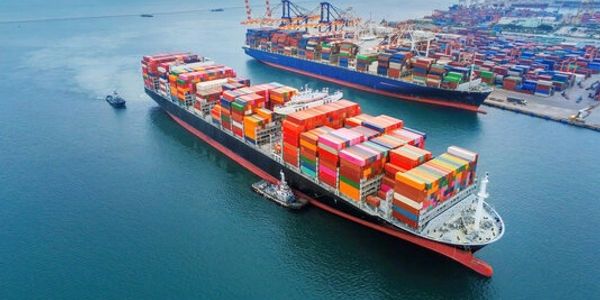 Cargo ships loaded with containers at sea and port.