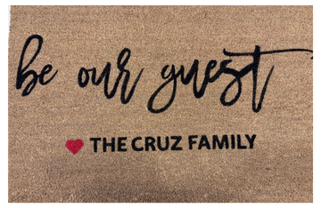 Welcome doormat saying 'be our guest' from the Cruz family.