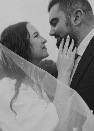 A bride and groom share an intimate moment on their wedding day.