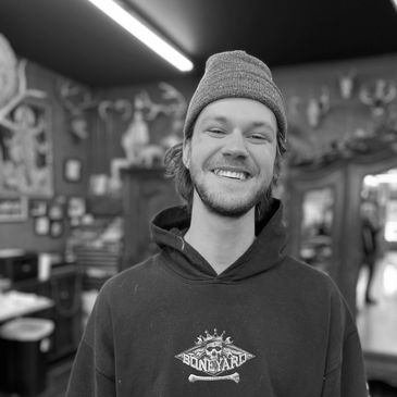 hank Thometz smiles in Boise tattoo company