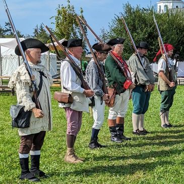 Colonial soldiers drilling in camp.