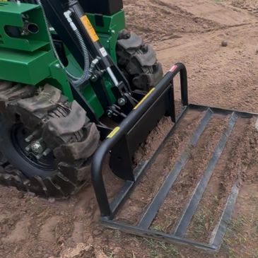 Tracked vehicle with a front attachment on dirt.