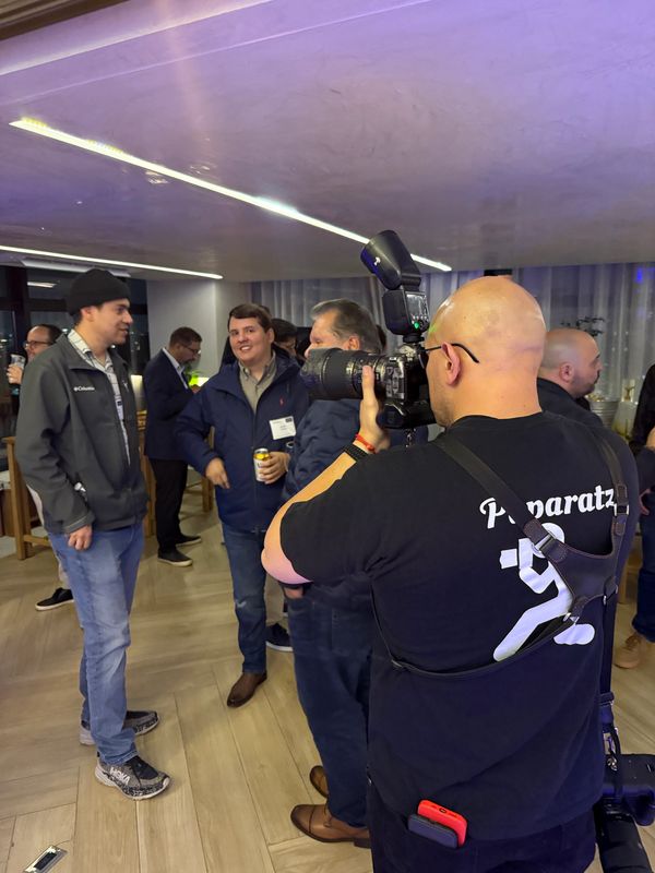 Photographer capturing candid moments at a social gathering indoors.