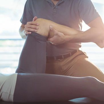 osteopath holding a patient's knee