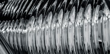 Close-up of metallic reflective structure with repeating patterns.