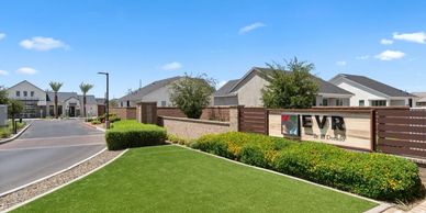 Entrance of a modern residential community with a clear EVR sign.