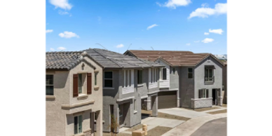 Newly constructed suburban houses under a clear blue sky.