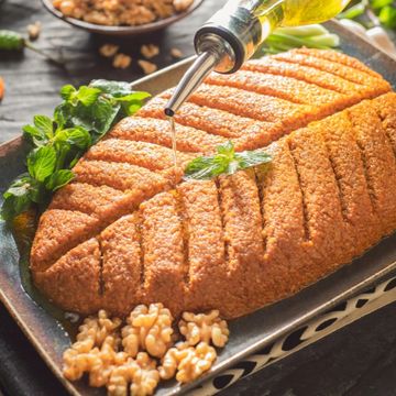 Traditional kibbeh served with olive oil and walnuts.