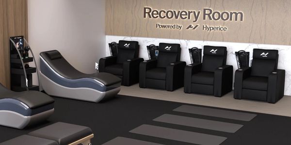 Modern recovery room with sleek chairs and loungers under the Recovery Room sign.