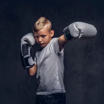 A child boxing in a class
