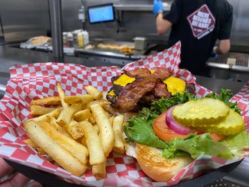 Burger with bacon and cheese served with french fries