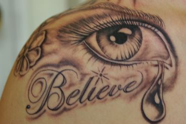 Lettering tattoo with an eye and tear.