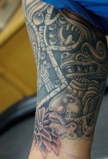 Black and grey Aztec sleeve tattoo.