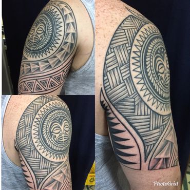 Black and grey tribal shoulder tattoo.