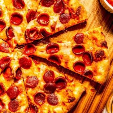 Pepperoni pizza slices on a wooden board.