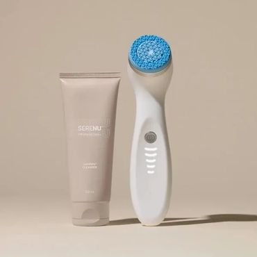 Facial cleansing brush with blue bristles and a tube of cleanser on a beige background.