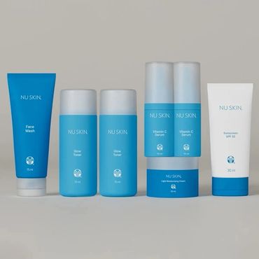 A lineup of six blue and white Nu Skin skincare products.