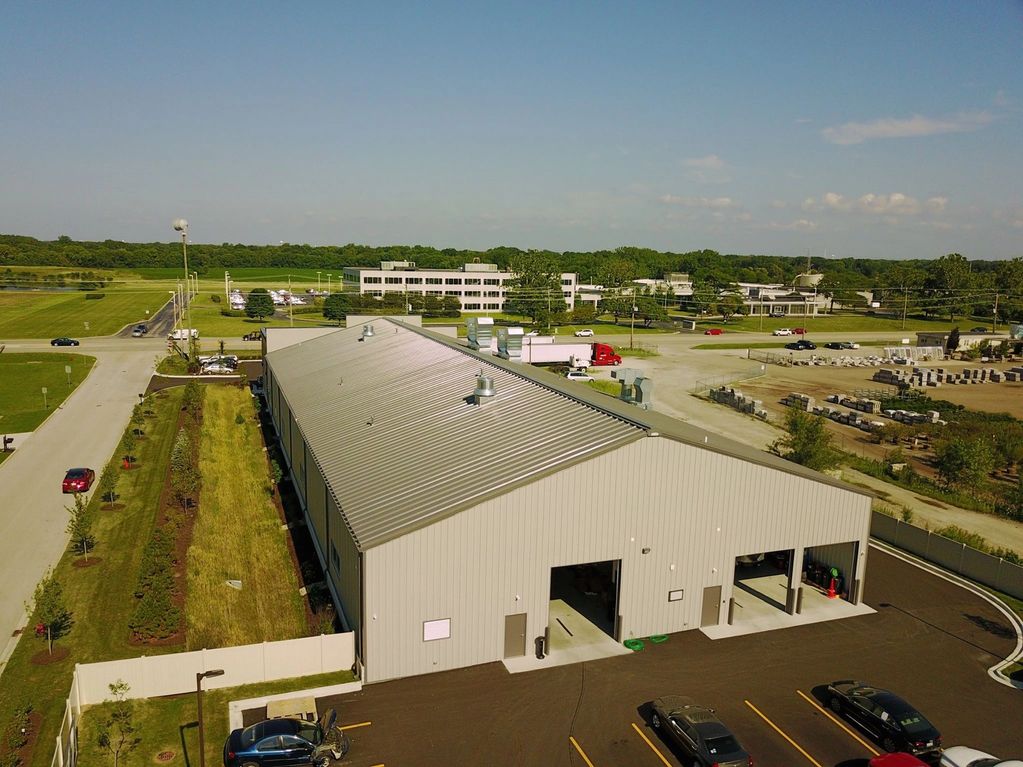 High slope pre-engineered metal building with painted roof.