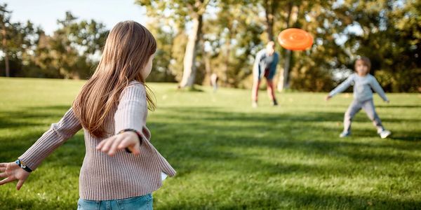 children playing frisbee in a park