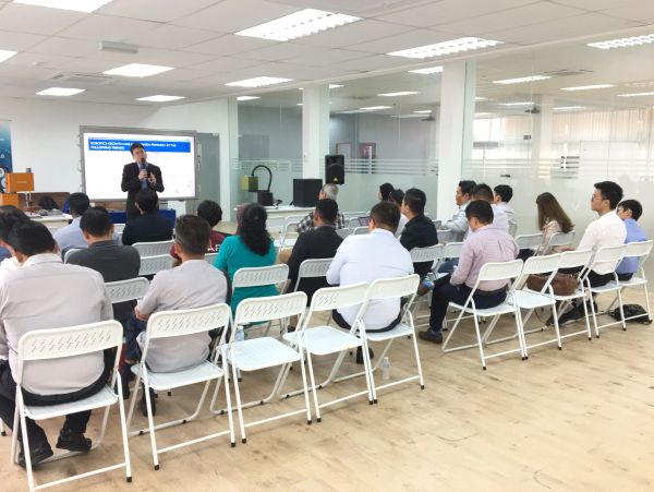 People attending a presentation in a modern office space.