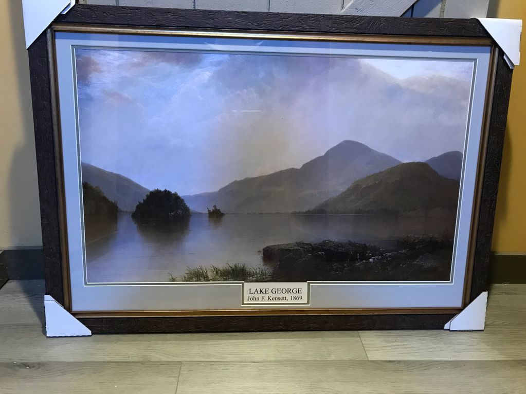 Framed painting "Lake George" by John F. Kensett, depicting serene mountains.