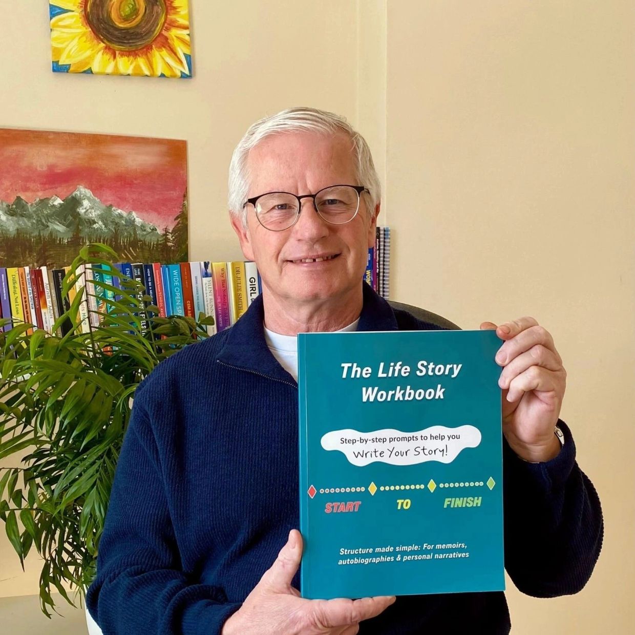 Man holding a life story workbook.