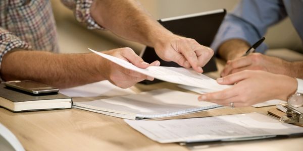 A couple and their mediator reviewing documents