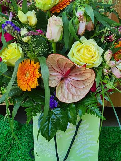 Beautiful collection in soft pink, orange and cream roses with fountain grass and a hint of purple 