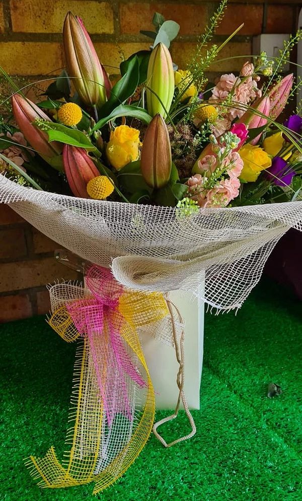 Hand Tied Bouquet Roses Stocks Lillys, wrapped in eco net wrap