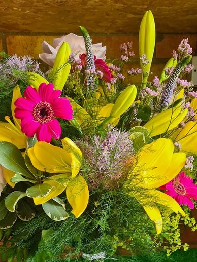 Yellow lillys and shocking pink gerbra lilac veronica 