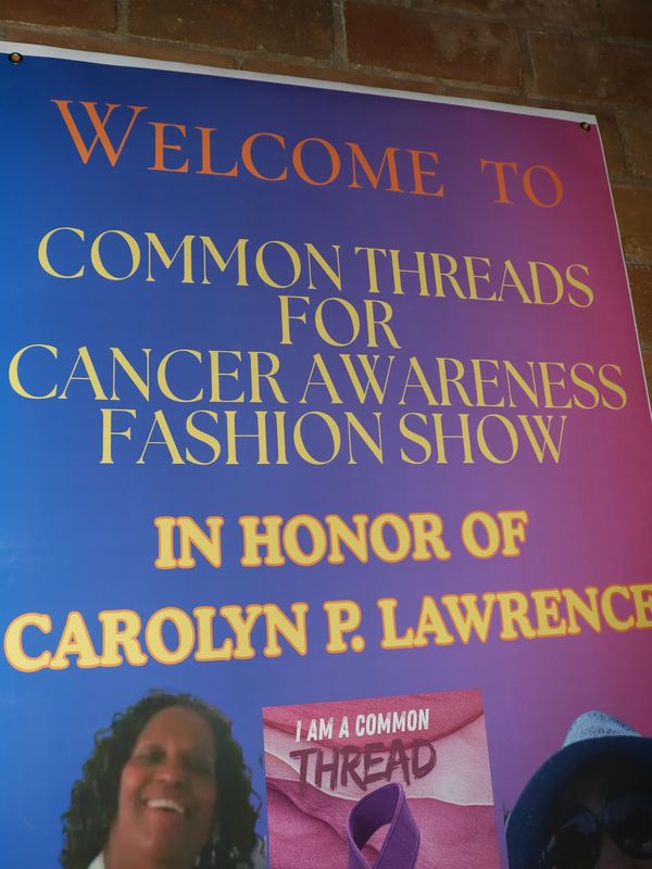 Sign for Common Threads cancer awareness fashion show honoring Carolyn P. Lawrence.