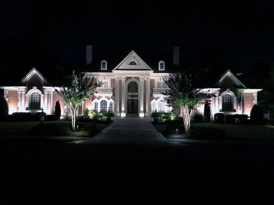 House with Landscape Lighting by Destin/30A Landscape Lighting and Holiday Decorating.