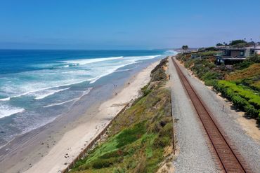 Aerial view of La Jolla beach and the coastal Amtrak train tracks.