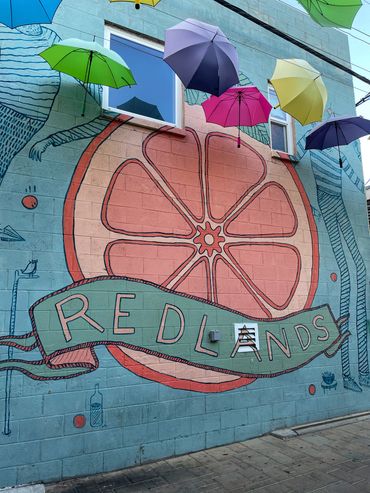 Photo of graffiti art with the city name Redlands drawn out in pastel colors.