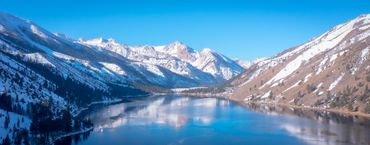 Partially frozen lake with snowy mountain at Twin Lakes, CA