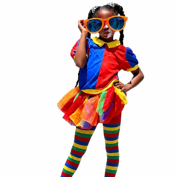 Child in colorful clown costume with oversized orange sunglasses.