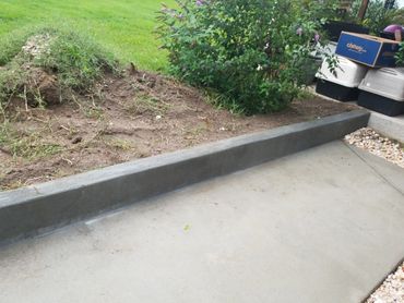 Concrete sidewalk with header curb to prevent water flooding North Augusta, SC