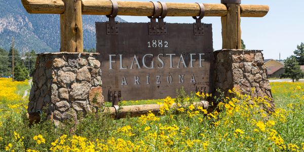 Large sign in grass field that says 1882 Flagstaff Arizona
