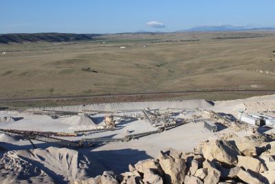A mining site with rocky terrain and conveyor belts.