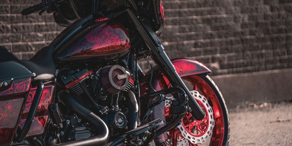 Black and red Harley Davidson completely customized with anodized wheels