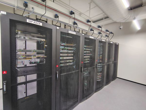 Row of server racks in a data center room.