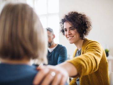 A carer greeting a person with mental health issues