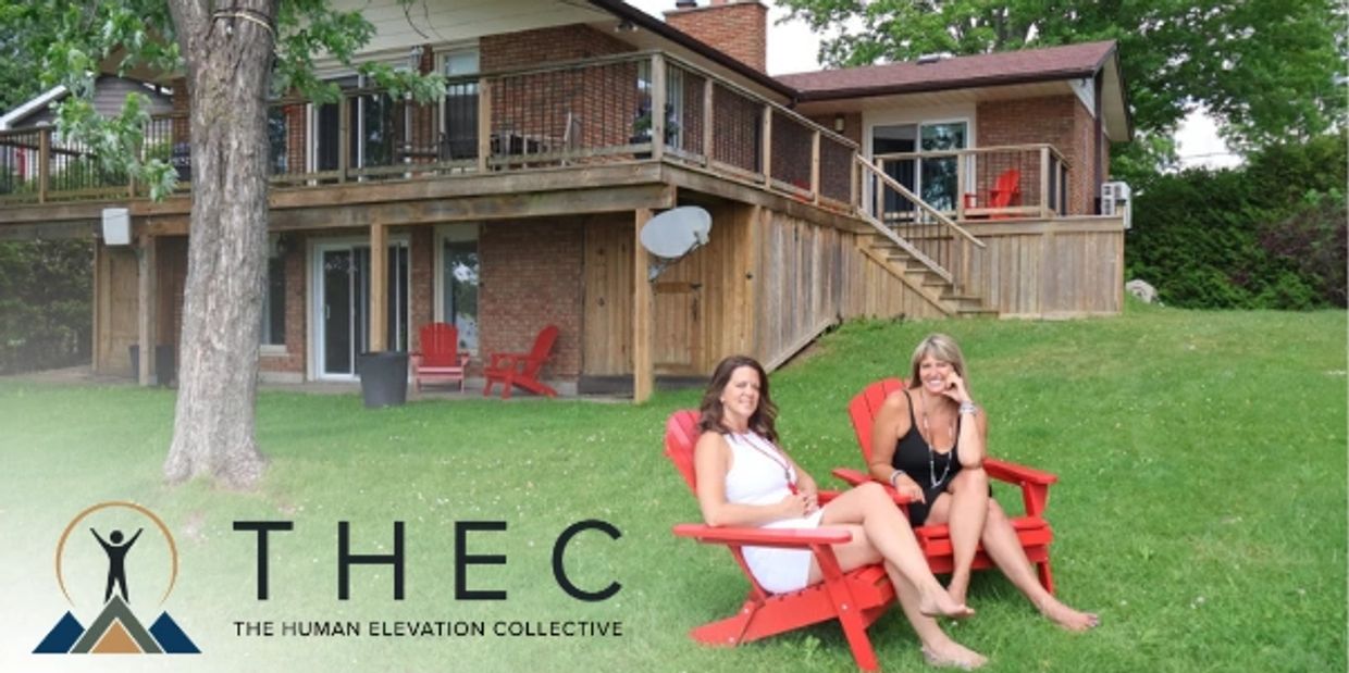 Two women sitting on red chairs in front of a house with a logo and text overlay.
