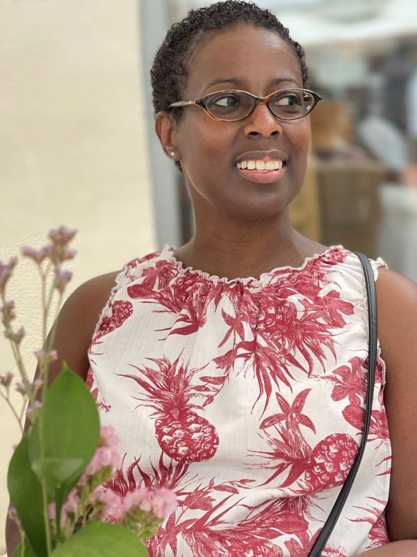 A woman in glasses and a red dress