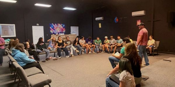 Group discussion in a room with chairs arranged in a circle.