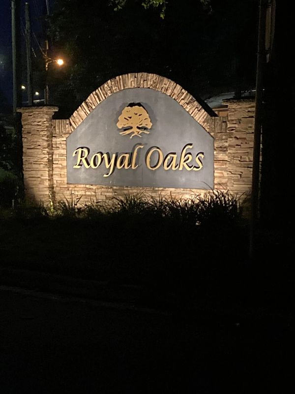 monument sign for a neighborhood with uplighting for better visibility in the dark.