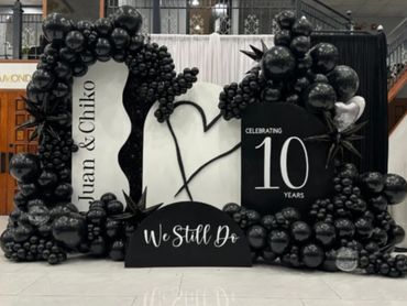 Black and white balloon display celebrating Juan and Chiko's 10-year anniversary.