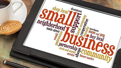 Tablet displaying words promoting small business and community support.